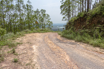 A winding sandstone road in the mountainous area