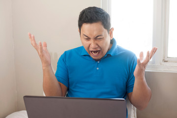Angry Man Disappointed Expression Looking at Laptop