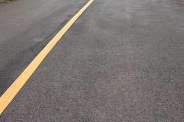 Yellow solid line asphalt pavement