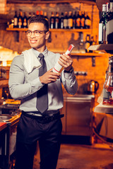 Elegant businessman wearing shirt and tie smiling standing at his bar