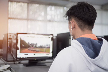 Reaw view Asian Student Male engineers using computer pc for seaching information data internet at technology center room