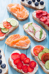 Variation of toast with fruit , vegetable and salmon