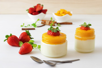 Traditional Italian sweet dessert Panna cotta with mango jelly with touch of red hot chili...
