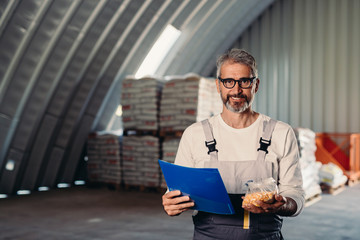 closeup of agribusiness worker holding corn seeds