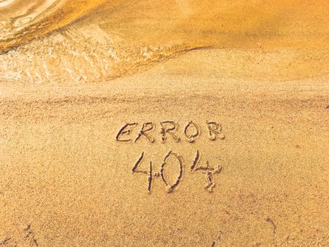 Error 404 text in sand.