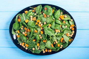 autumn salad with pumpkin , spinach , chickpea and sesame