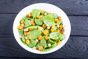 autumn salad with pumpkin , spinach , chickpea and sesame