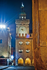 Fototapeta na wymiar Bologna, Italy. The clock tower Piazza Maggiore at night