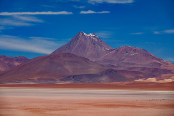 Highlands typical landscape with salar, volcanoes and bright color