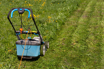 Lawn mower in the spring garden