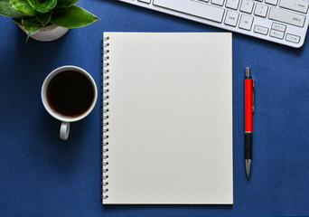 Top view, empty notebook on a blue background