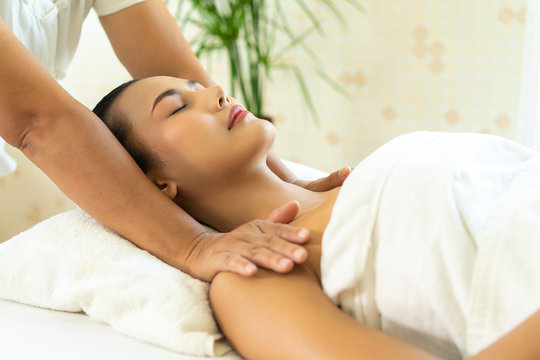 happy Young Asian woman having massage in spa salon environment. professional masseuse massage of female neck and shoulder. Leisure. lifestyle beauty woman concept