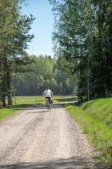 Woman bicycling on the road