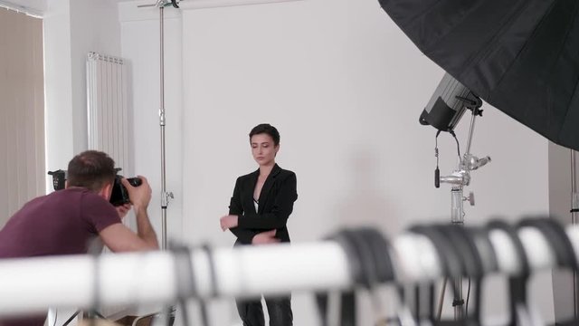 Handheld shot of photographer and model during a fashion photoshoot in the studio