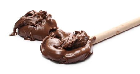 Cream chocolate spread with wooden spoon isolated on white background