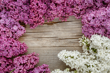 Background of lilac flowers on a wooden surface