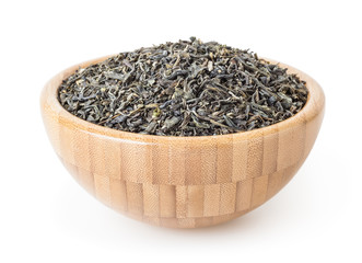 Dried green tea leaves in wooden bowl isolated on white background with clipping path