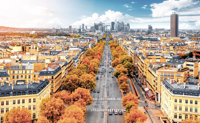 Fototapeta na wymiar La Defense Financial District Paris France in autumn. Traffic on Champs-Elysees. Trees with orange and yellow leafs.