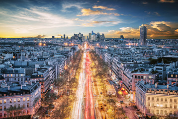 Beautiful sunset over La Defense Financial District Paris France. Traffic on Champs-Elysees with...