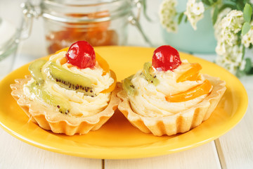 tarts with fruit and vanilla cream with cherry and kiwi