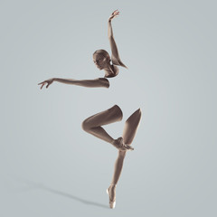 Graceful ballet dancer or classic ballerina dancing isolated on studio background. Woman's beautiful dance. The grace, artist, contemporary, movement concept. Abstract design.