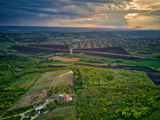 Fototapeta premium Flight over cultivating field in the spring at sunset. Moldova Republic of.