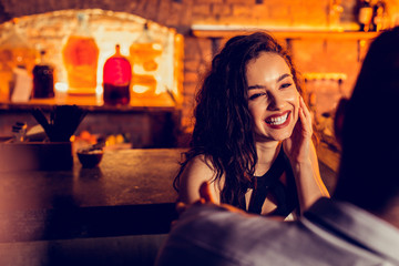 Cheerful girlfriend spending time with her man in bar