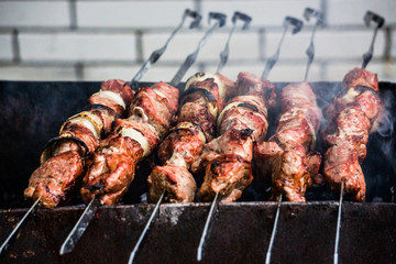 delicious barbecue grill on the open grill, open kitchen. Delicious food, frying on skewers, food court. summer picnic