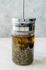Green Tea with French Press in Daylight