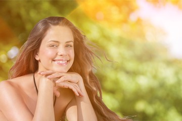 Fototapeta premium Young relaxed woman on blurred nature background