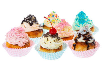 setting of birthday cupcakes with butter cream icing and decorated sprinkles isolated on white background, concept of baby party