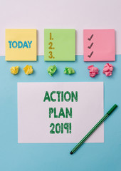 Conceptual hand writing showing Action Plan 2019. Concept meaning proposed strategy or course of actions for current year Stationary placed sideways on top of the softhued backdrop