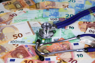 Medical cost concept - Stethoscope on euro paper money bank notes