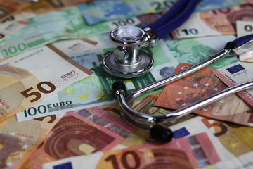 Medical cost concept - Stethoscope on euro paper money bank notes