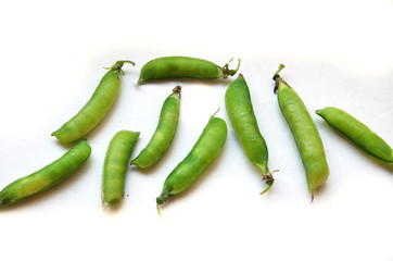 green peas in pods on a white background