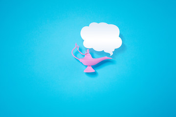 Pink wish lamp lie on pastel blue background. Minimal summer concept.