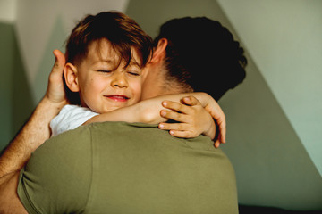 Smiling Son hugging his father