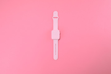 Pink watch lie on pastel pink background. Minimal summer concept.