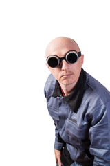 A man in working clothes, in dark gas-welding glasses. A man of middle age, European appearance, in a working overalls. Isolated on white background