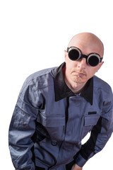 Obraz premium A man in working clothes, in dark gas-welding glasses. A man of middle age, European appearance, in a working overalls. Isolated on white background