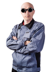 A man in working clothes, in dark gas-welding glasses. A man of middle age, European appearance, in a working overalls. Isolated on white background