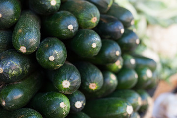 Fresh zucchini on market counter in wicker basket