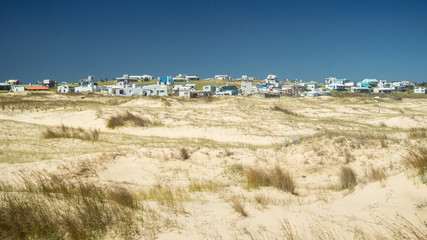 Houses on the sand dunes of the Cabo Polonio National Park in Uruguay