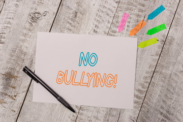 Handwriting text No Bullying. Conceptual photo stop aggressive behavior among children power imbalance Plain note paper and line arrow stickers with pen above the wooden table