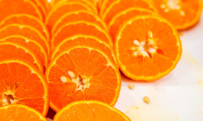 Fresh cut orange fruit background, many pieces of oranges, macro close up photo of healthy food, top view