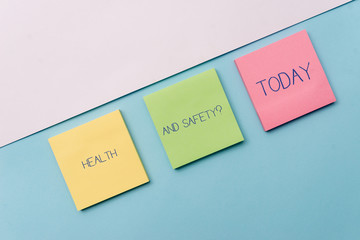 Text sign showing Health And Safety Question. Business photo showcasing regulations and procedures to prevent accident or injury Pastel colour note papers placed sideways on the of softhued backdrop