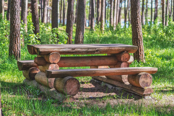 Wooden bench and table of tree trunks.