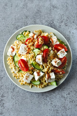 Salad with bulgur, vegetables and feta cheese. Healthy food. Middle Eastern style.