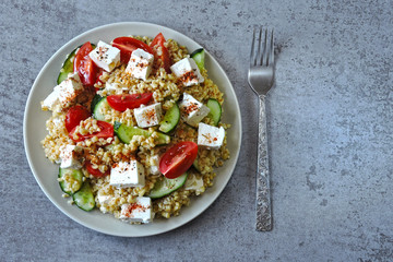 Salad with bulgur, vegetables and feta cheese. Healthy food. Middle Eastern style.
