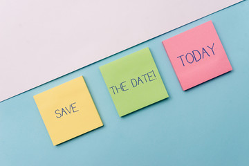 Text sign showing Save The Date. Business photo showcasing remember not schedule anything else on this day Pastel colour note papers placed sideways on the of softhued backdrop